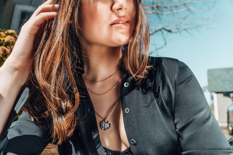 Alexander Drake necklace worn with a black shirt outdoors